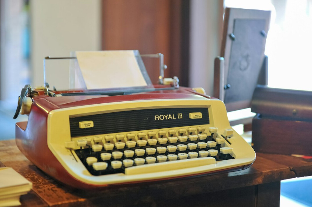 Vintage typewriter with a blank page on a desk